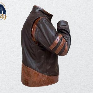 May include: A brown leather jacket with a high collar and brown stripes on the sleeves. The jacket has a two-tone design, with a darker brown body and lighter brown accents. The jacket is a classic style.