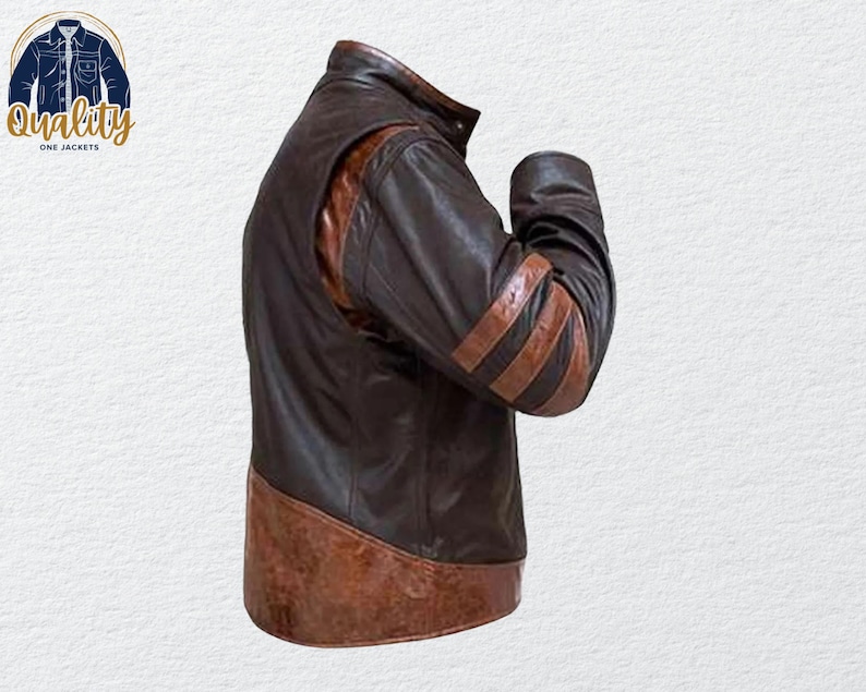 May include: A brown leather jacket with a high collar and brown stripes on the sleeves. The jacket has a two-tone design, with a darker brown body and lighter brown accents. The jacket is a classic style.