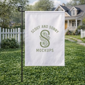 May include: A white garden flag with the text "SCOUT AND SONNY MOCKUPS" in green. The letter "S" is stylized with floral elements. The flag is displayed on a black metal stand in a grassy yard, with a white picket fence and a house in the background.