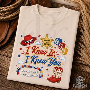 May include: A cream-colored t-shirt featuring a graphic print with a red cowboy hat, a yellow sheriff star badge labeled INFINITY AND BEYOND, colorful blocks, a beaded bracelet with the text YOU'VE GOT A FRIENDIME, and red cowboy boots.