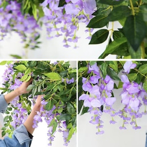 May include: Cascading artificial wisteria vines with clusters of lavender-colored flowers and green leaves. The image shows the wisteria in various stages of arrangement, suggesting its use in home decor or event styling.