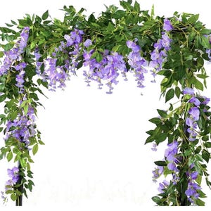 May include: Artificial wisteria garland with cascading purple flowers and green leaves. The garland is arranged in an arch shape, perfect for weddings, parties, or home decor. The flowers are a vibrant shade of purple, and the leaves are a deep green.