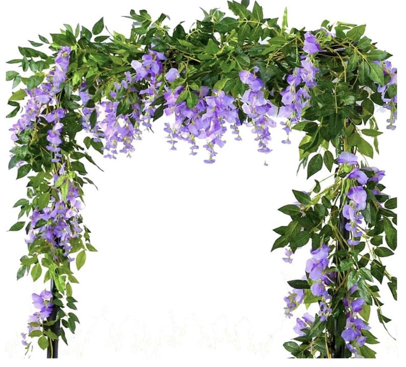 May include: Artificial wisteria garland with cascading purple flowers and green leaves. The garland is arranged in an arch shape, perfect for weddings, parties, or home decor. The flowers are a vibrant shade of purple, and the leaves are a deep green.