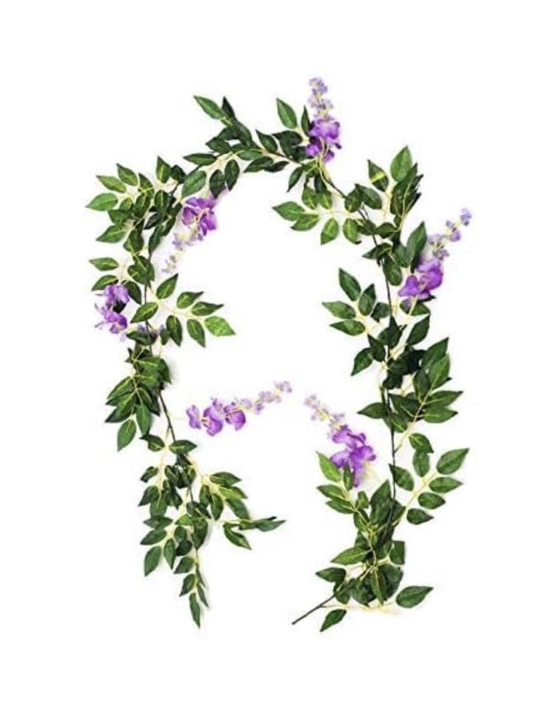 May include: Artificial wisteria garland featuring vibrant purple flowers and lush green leaves. This decorative garland is ideal for adding a touch of nature to any space, perfect for weddings, parties, or home decor.