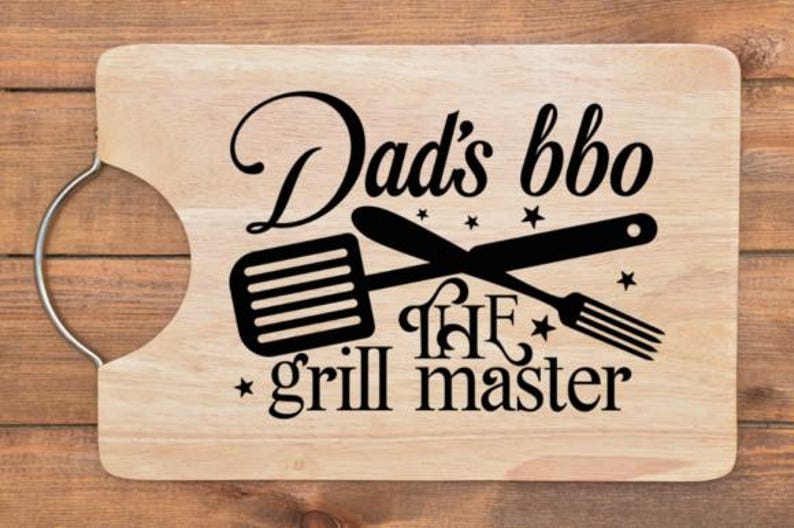 May include: Wooden cutting board with a handle, featuring the text "Dad's bbq the grill master" in black. The design includes crossed spatula and fork illustrations, and star accents.