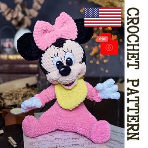 May include: A handmade crochet Minnie Mouse doll in pink, black, and white, with a yellow bib and a large pink bow. The doll is sitting, with the text "CROCHET PATTERN" in a vertical format. An American flag and a PDF download icon are also visible.