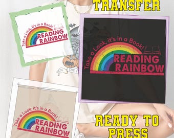 May include: DTF transfer featuring a rainbow design with the text "Reading Rainbow" and "Take a Look, it's in a Book!". The design is ready to press onto fabric. The image shows the design in multiple formats.
