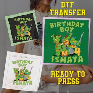 May include: DTF transfer featuring a Teenage Mutant Ninja Turtles design. The design includes the text "BIRTHDAY BOY" and "ISMAYA" with the number "4". The words "READY TO PRESS" are also visible.