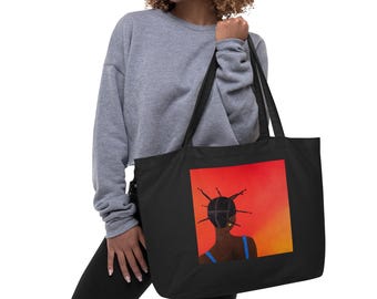 May include: Black tote bag featuring a vibrant square print of a person with dark skin and a unique hairstyle, set against a red and orange gradient background. The person is wearing a blue top. The bag has long handles.
