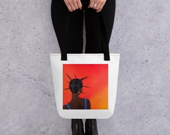 May include: White tote bag featuring a vibrant painting of a person with dark skin and intricate hairstyle, set against a gradient red and orange background. The person is wearing a blue top. Black tote bag straps.