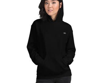 May include: A black hooded sweatshirt with a front pocket and a small white embroidered logo on the upper chest. The sweatshirt is made of a soft material and is worn by a person.