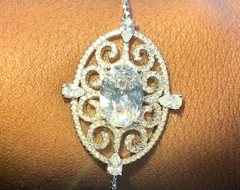 Adjustable Silver Bolo Bracelet with a Cubic Zirconia Filigree Centerpiece.