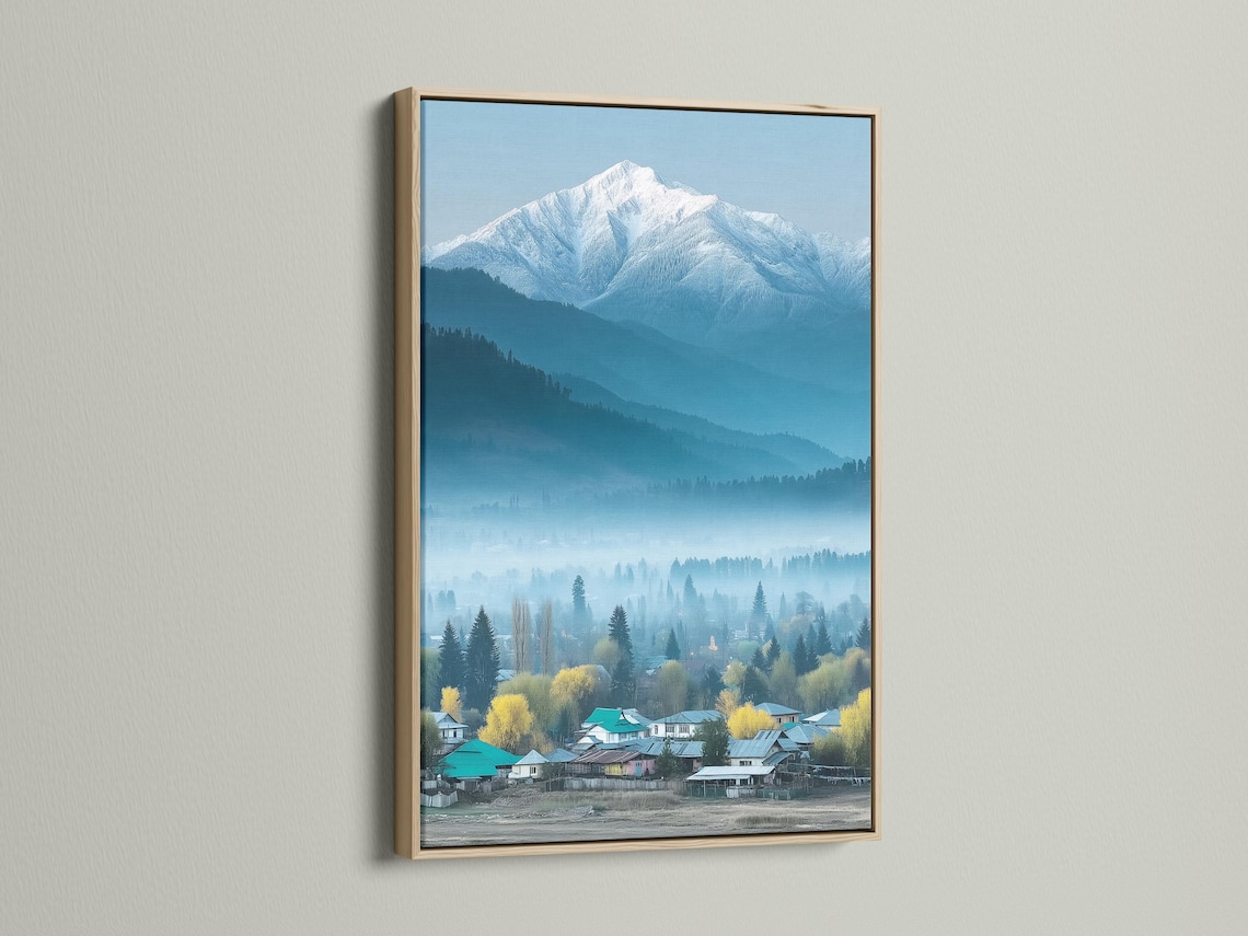 Misty snowy mountain landscape with evergreen trees and a village in teal and blue tones detail view
