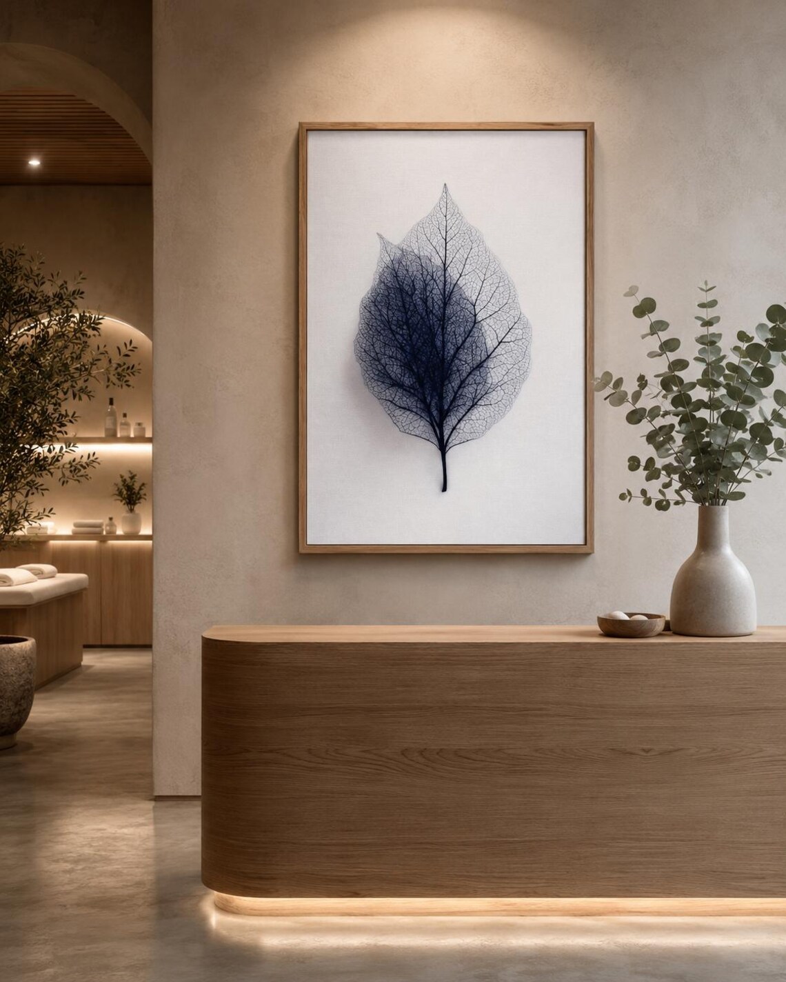 A person looking at a framed leaf skeleton wall artwork in a bright room