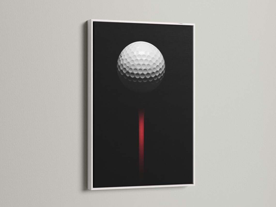 Minimalist golf ball design on a black background with a vivid red vertical accent detail view