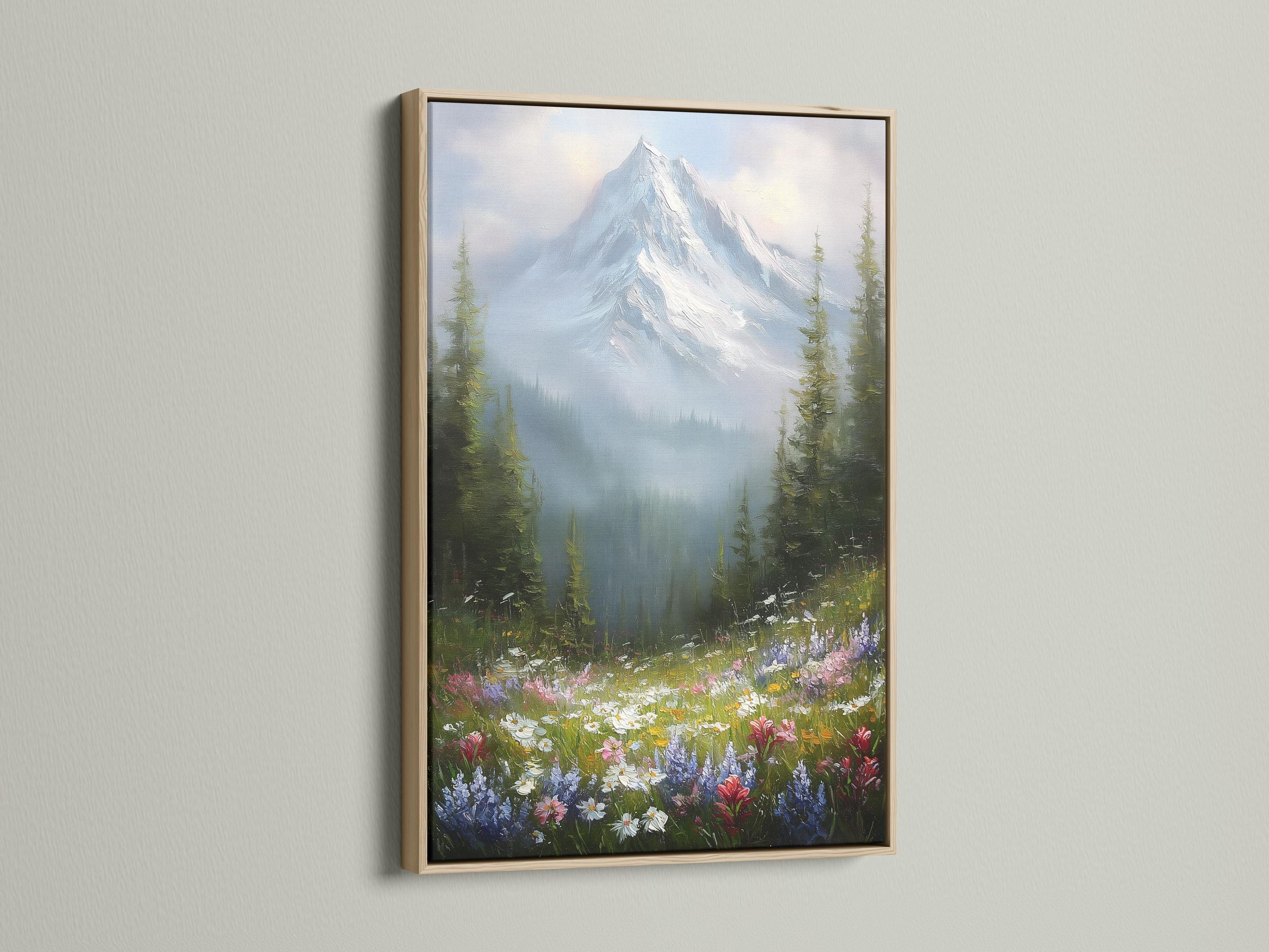 Wall mockup featuring a framed snowy mountain landscape with wildflowers and forest trees