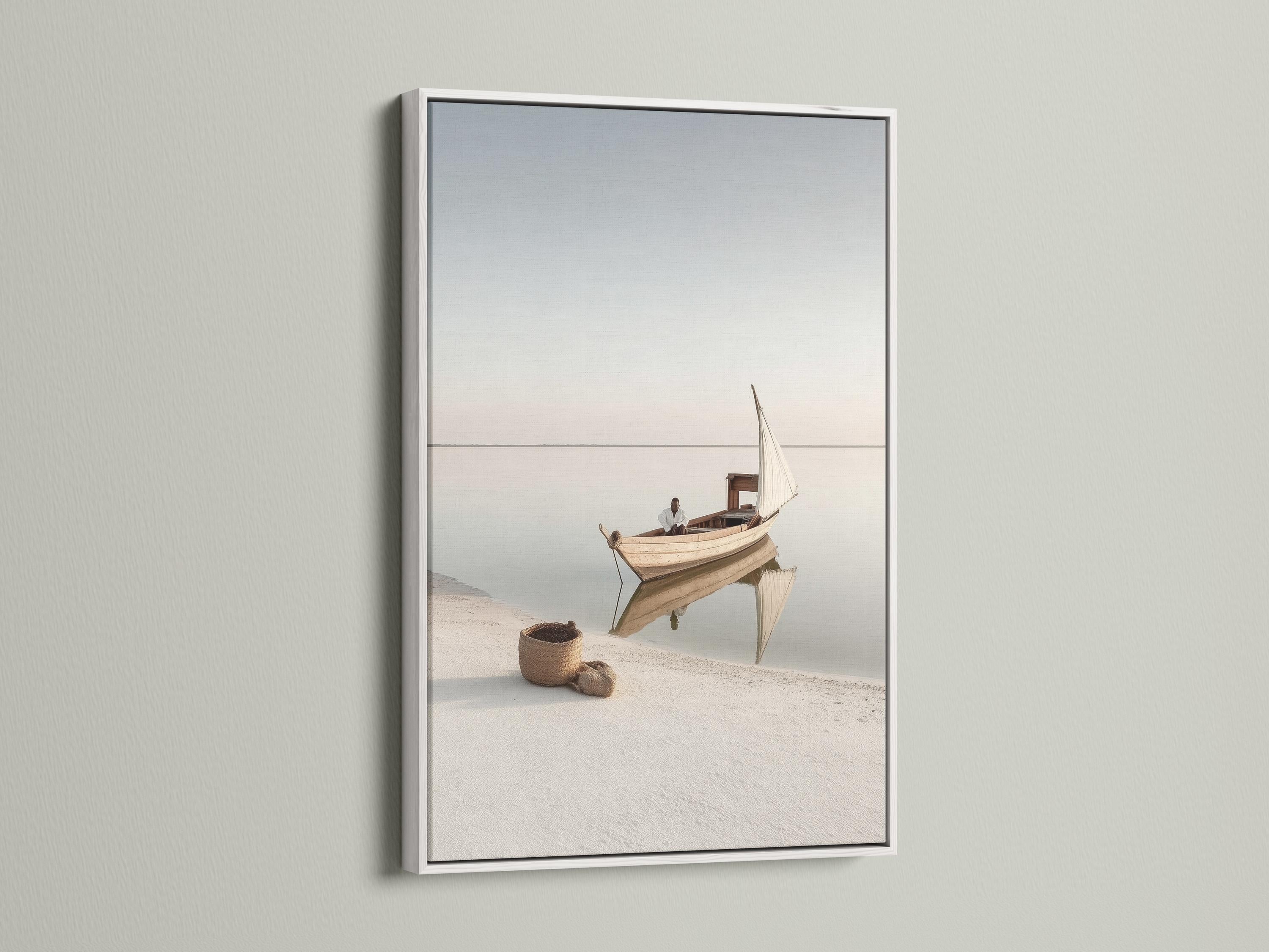 Neutral sailboat seascape with a pale sail on calm water and a hazy horizon detail view