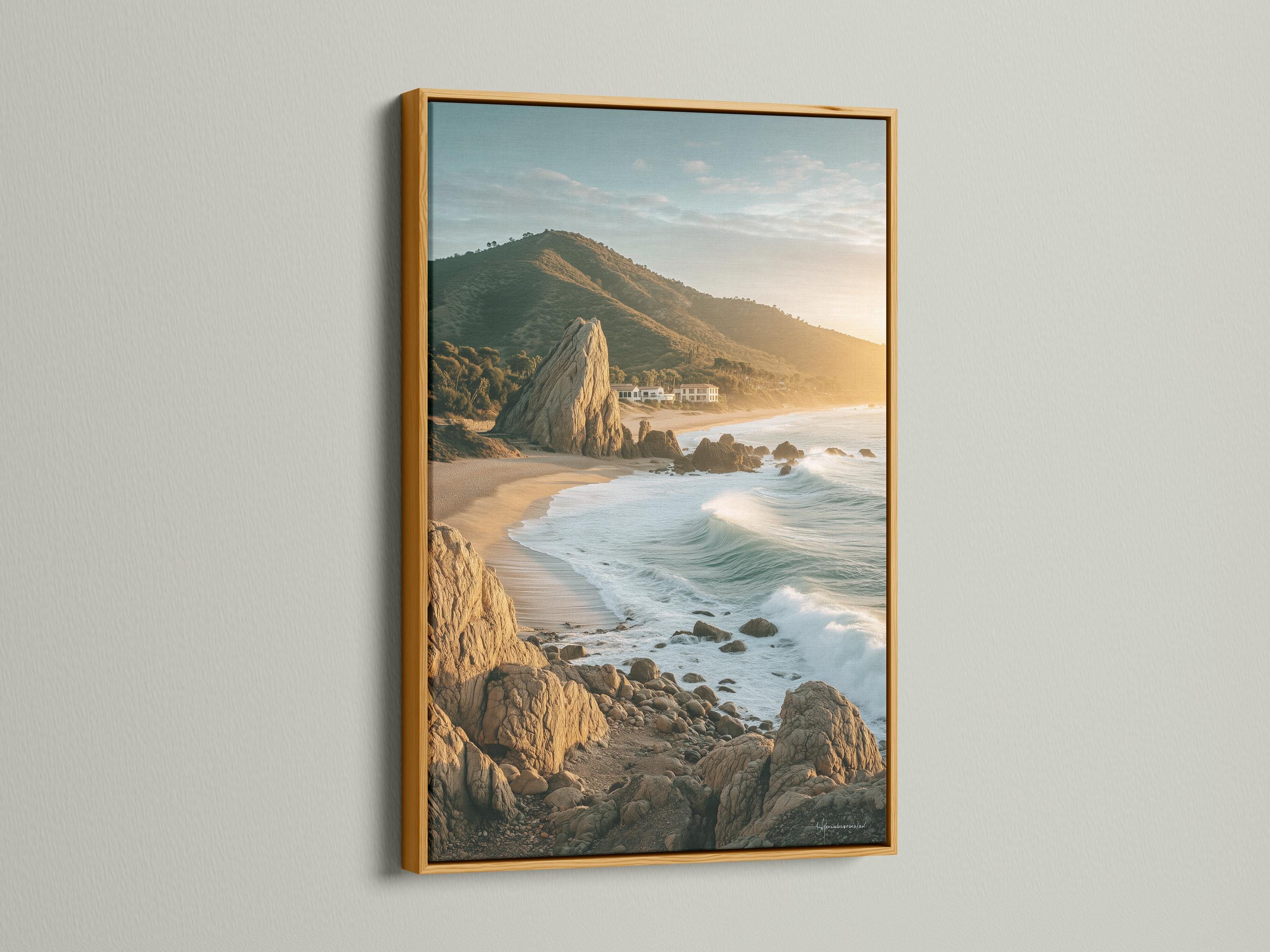 Golden hour seascape showing sandy shore, foamy waves, rocky cliffs and headland detail view