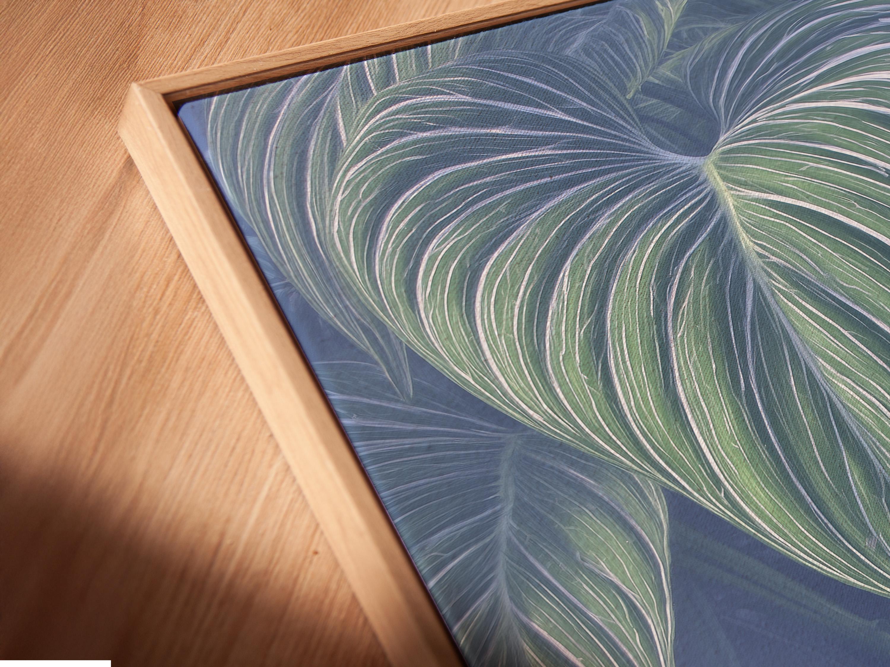 Mockup showing a framed botanical leaf artwork with mint green leaves on a navy-blue background