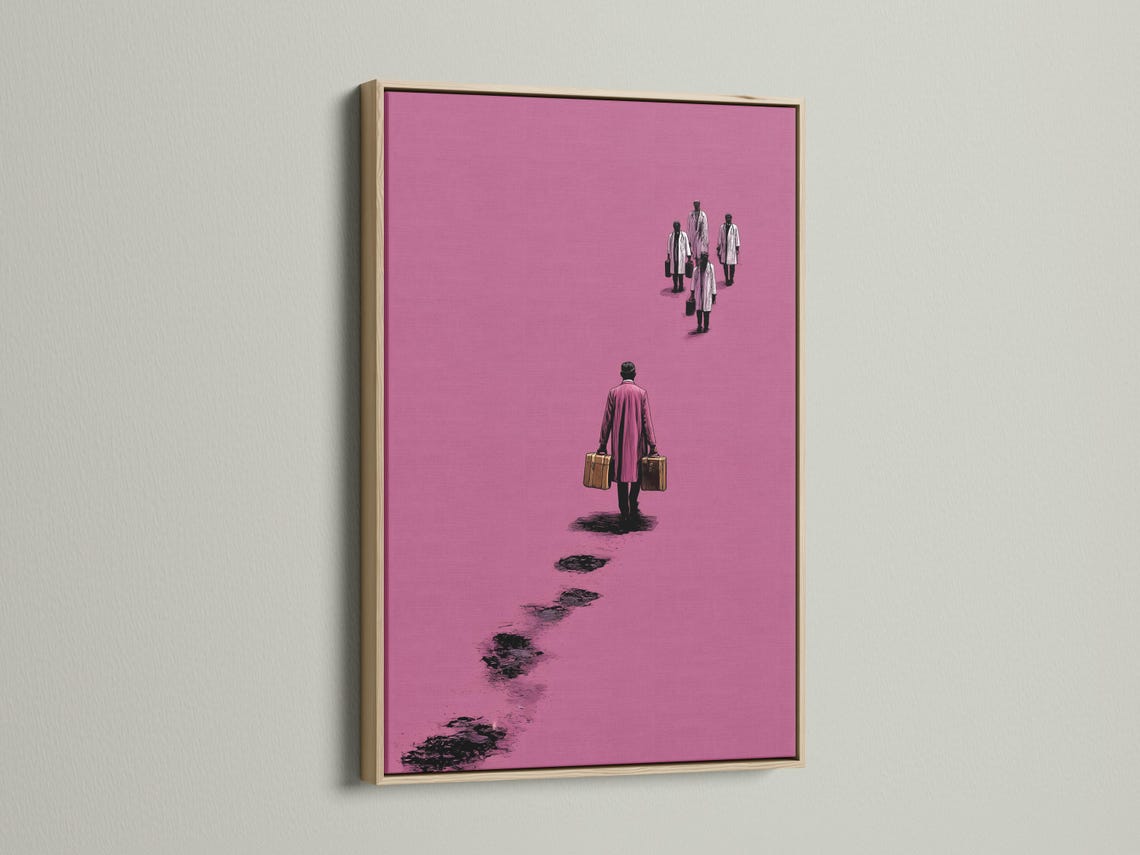 Mockup showing a framed pink minimalist traveller figure artwork on a light background