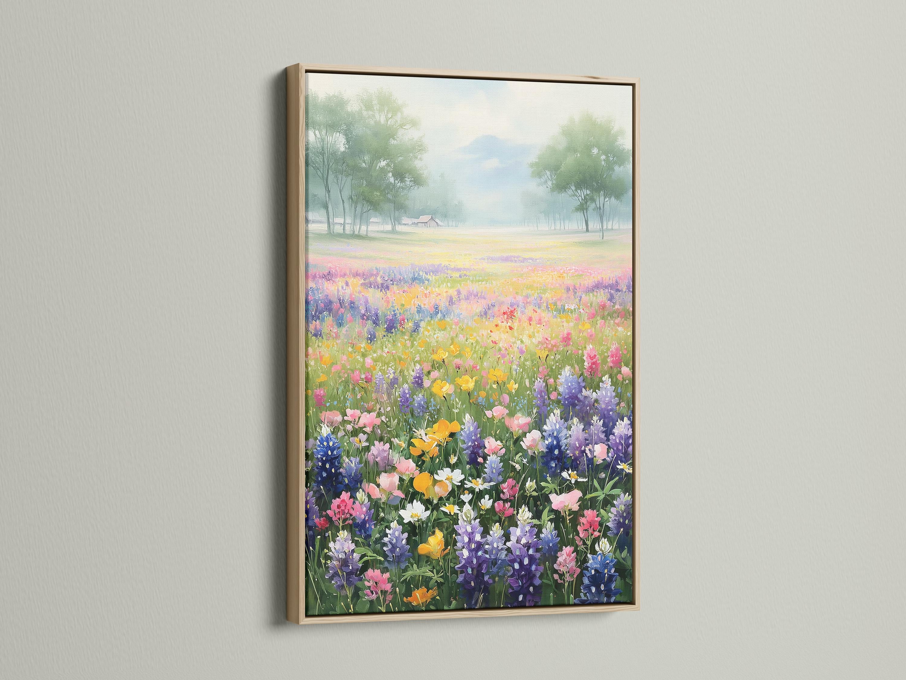 Pastel wildflower meadow with colourful flowers in the foreground and misty trees in the distance detail view