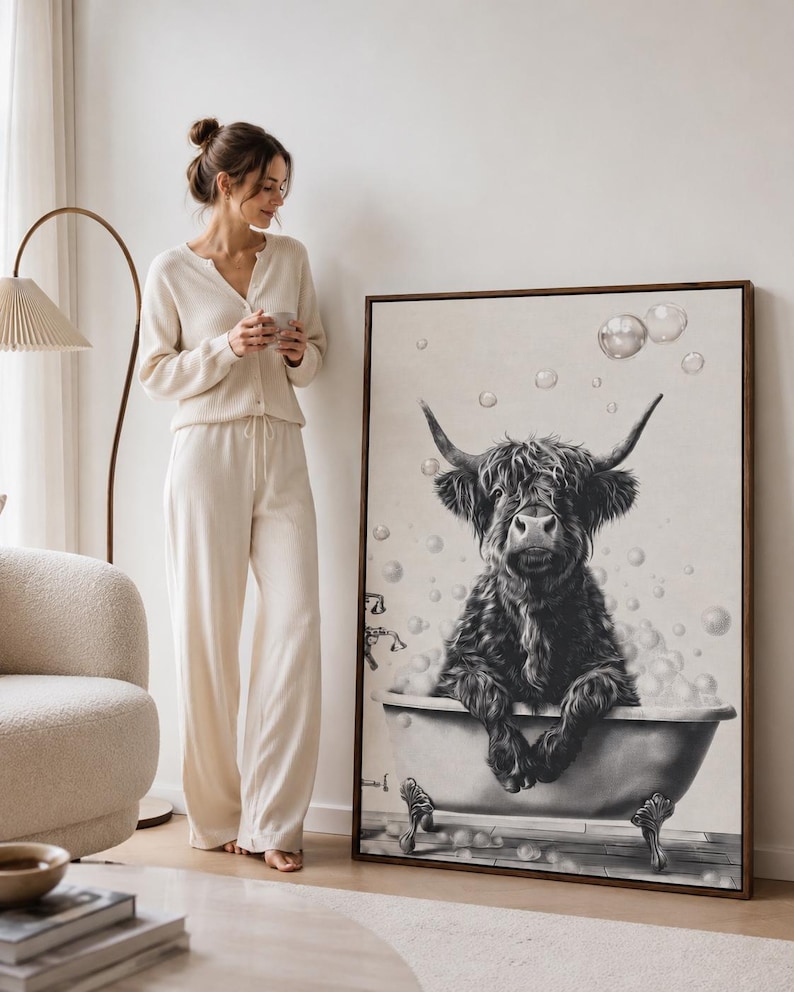 Black and white line drawing of a highland cow in a bathtub with bubbles