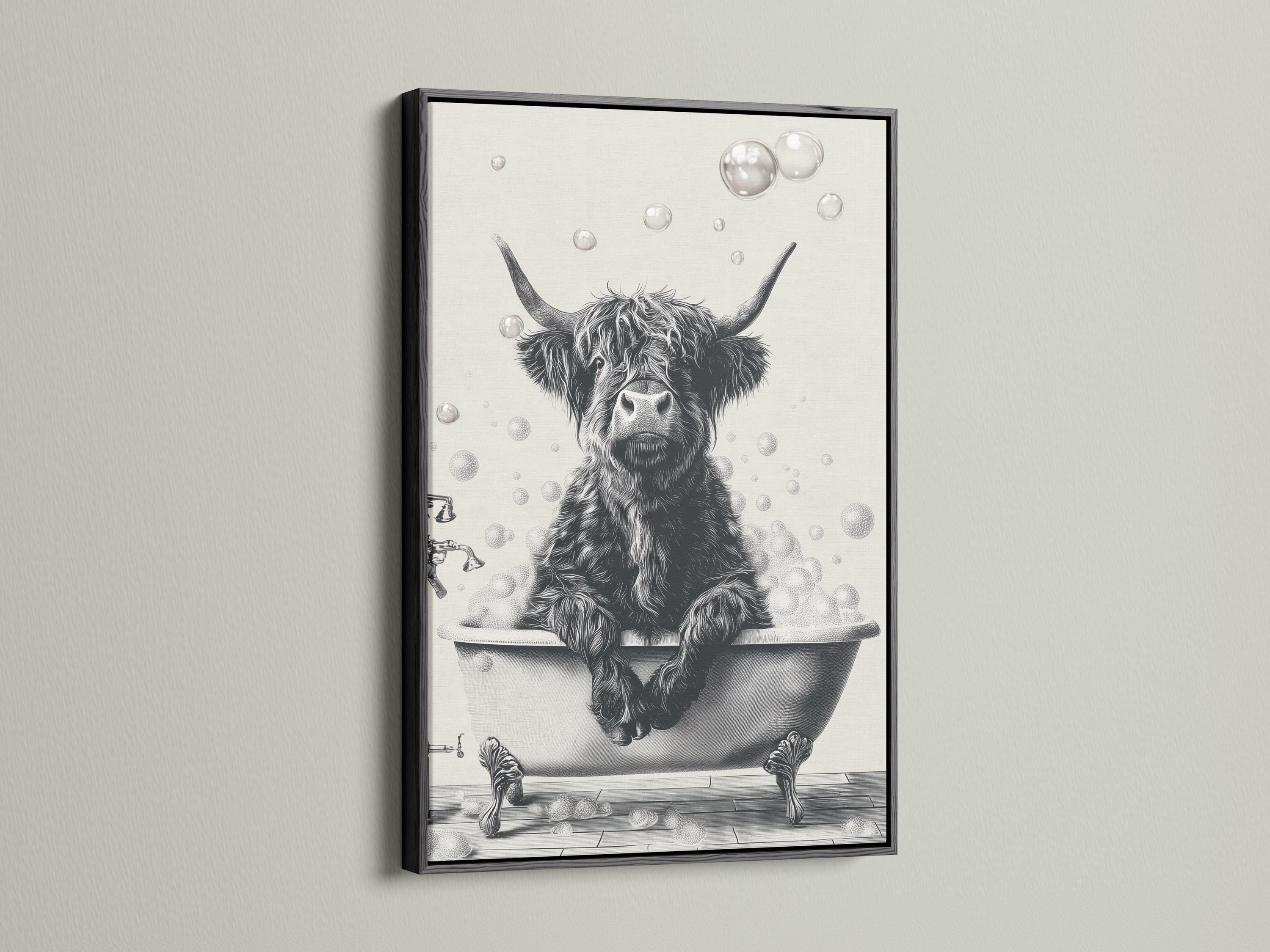 Woman holding a mug standing beside a framed monochrome highland cow bathtub artwork