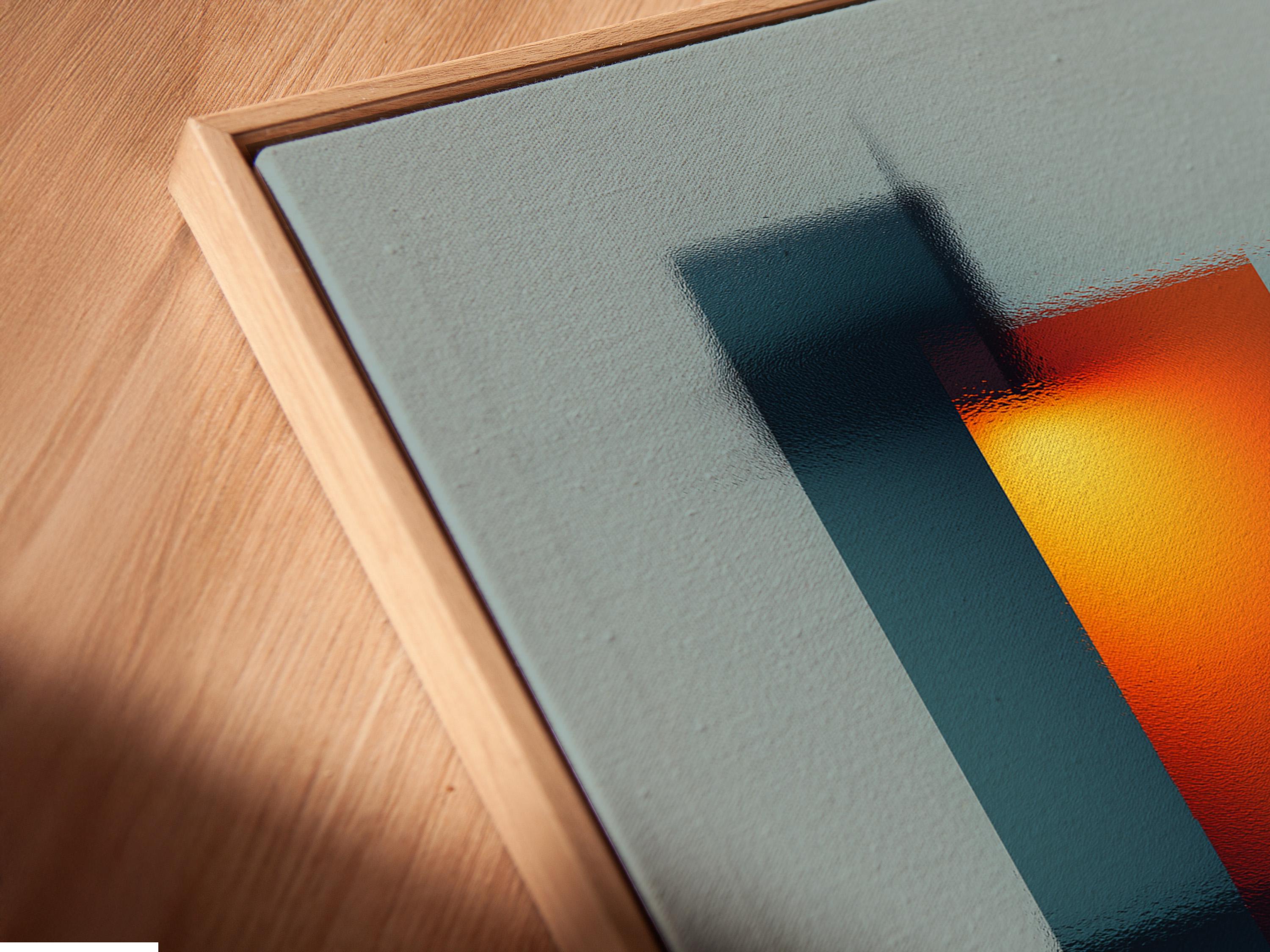 Room mockup showing a framed abstract geometric artwork with teal, deep blue and orange blocks