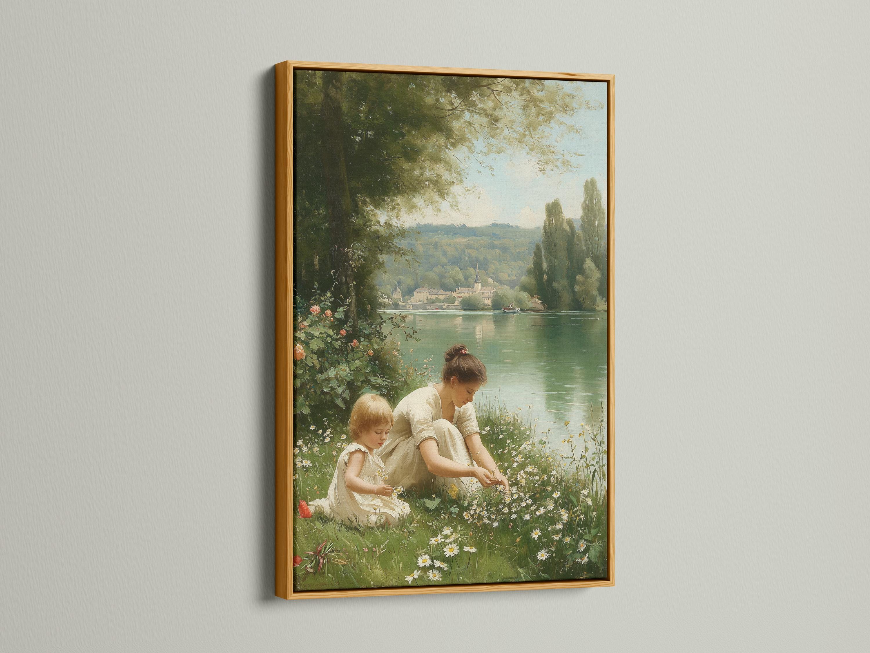 Mother and child sitting in a meadow by a calm lake with trees and distant buildings detail view