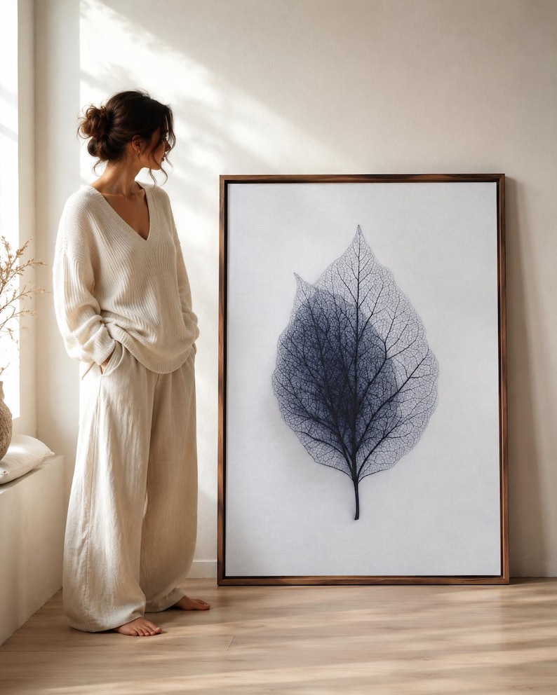 Minimalist leaf skeleton illustration with fine vein lines in blue-grey on a light background