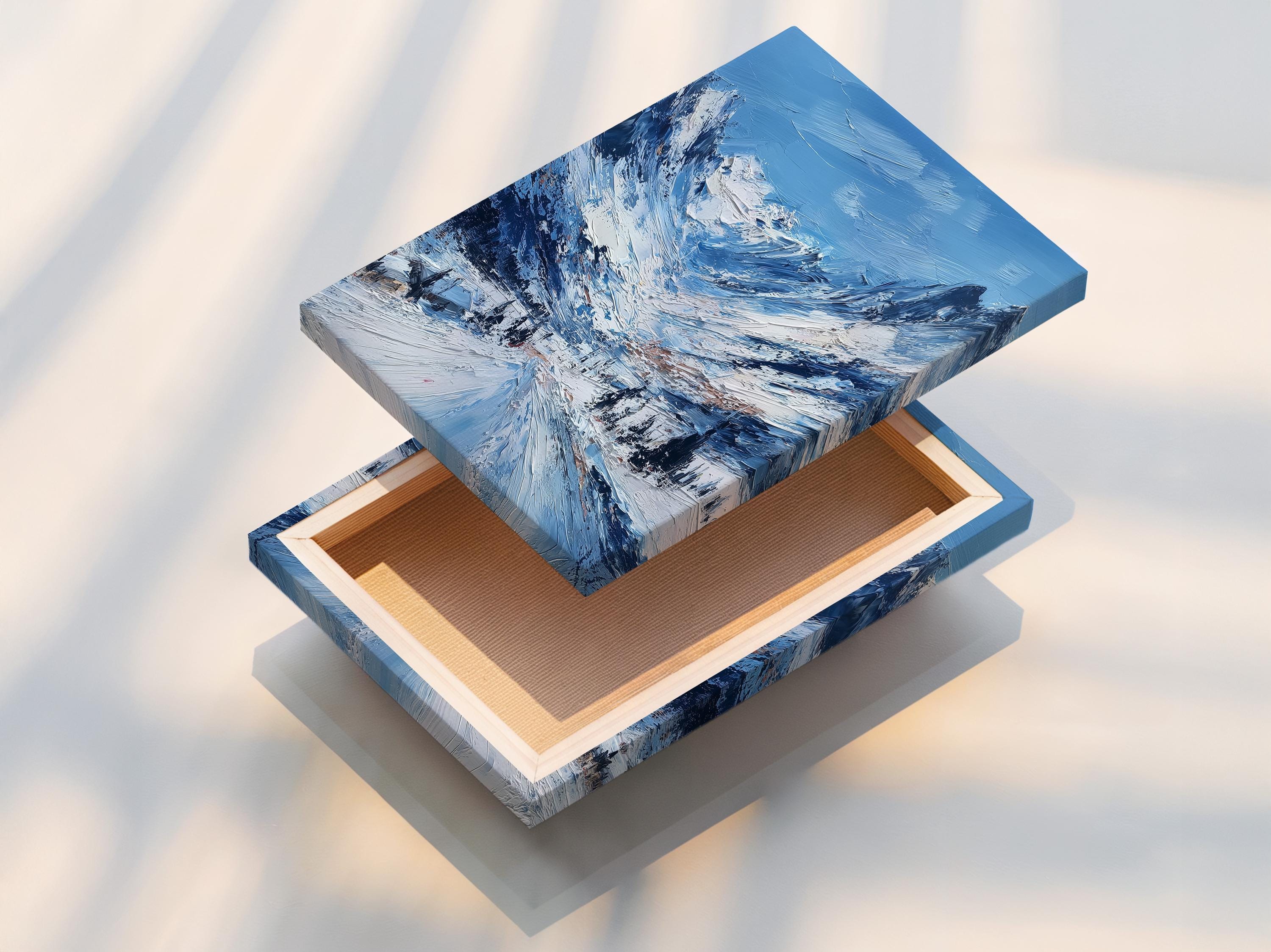Mockup showing a framed snowy mountain artwork against a light background with rolled print pieces