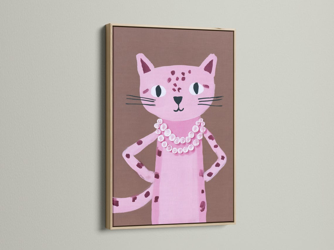Portrait of a pink cat with large eyes and a white and pink rosette collar on a taupe background detail view