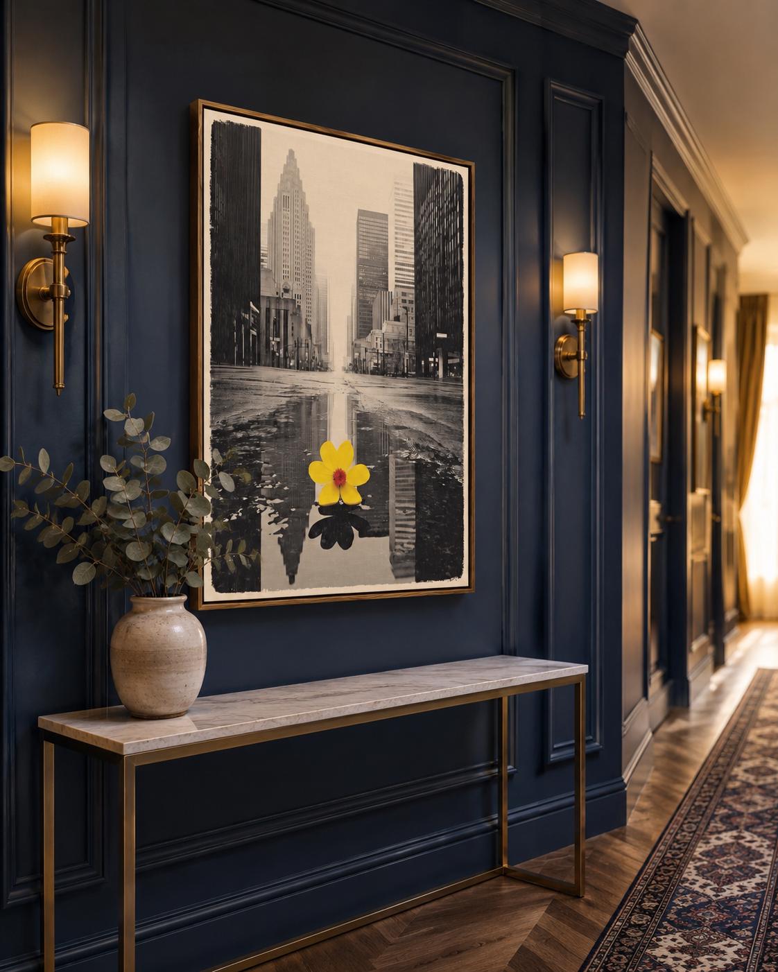 A monochrome city skyline is overlaid with a single bright yellow flower, reflected in water-like bands, creating a high-contrast urban accent detail