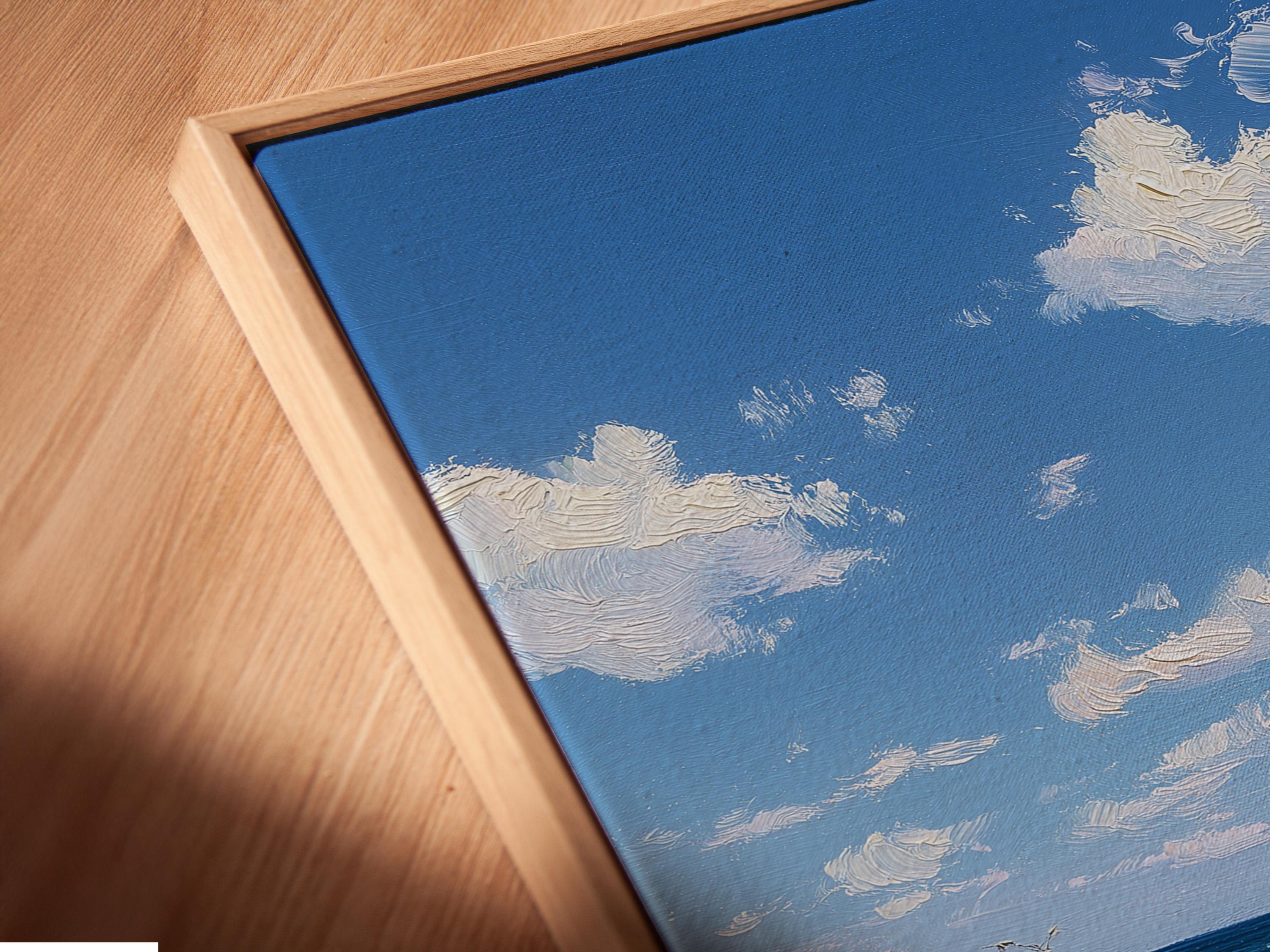 Room mockup showing a framed blue beach seascape artwork on a wall