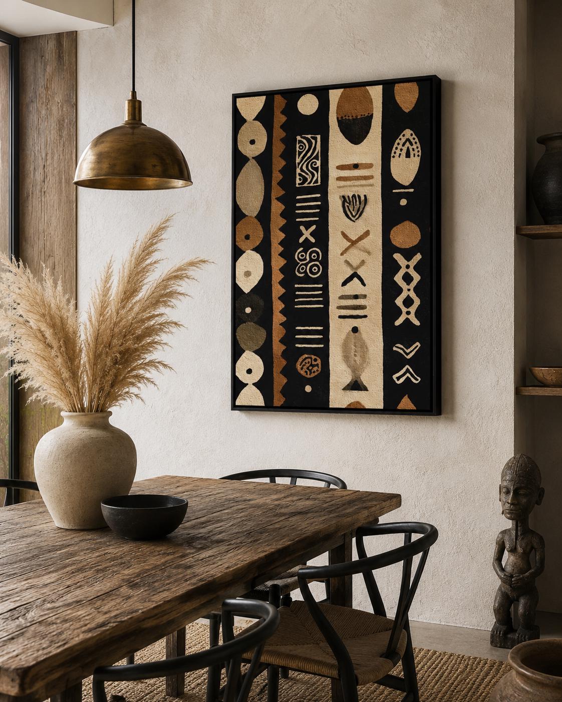 Man standing near a wall holding a drink next to a framed geometric tribal pattern artwork