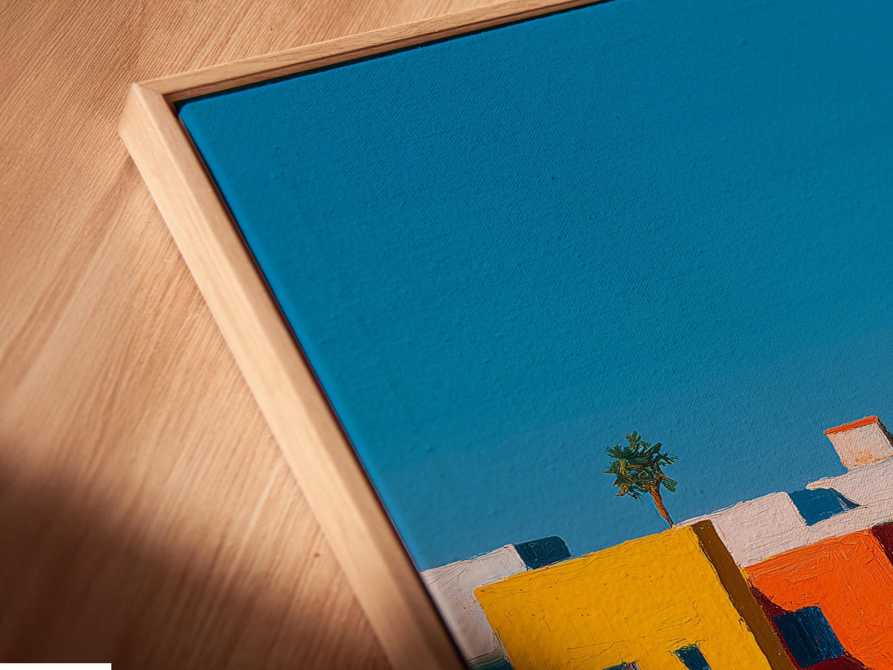 Wall mockup showing a framed coastal village artwork with colourful buildings and blue sky