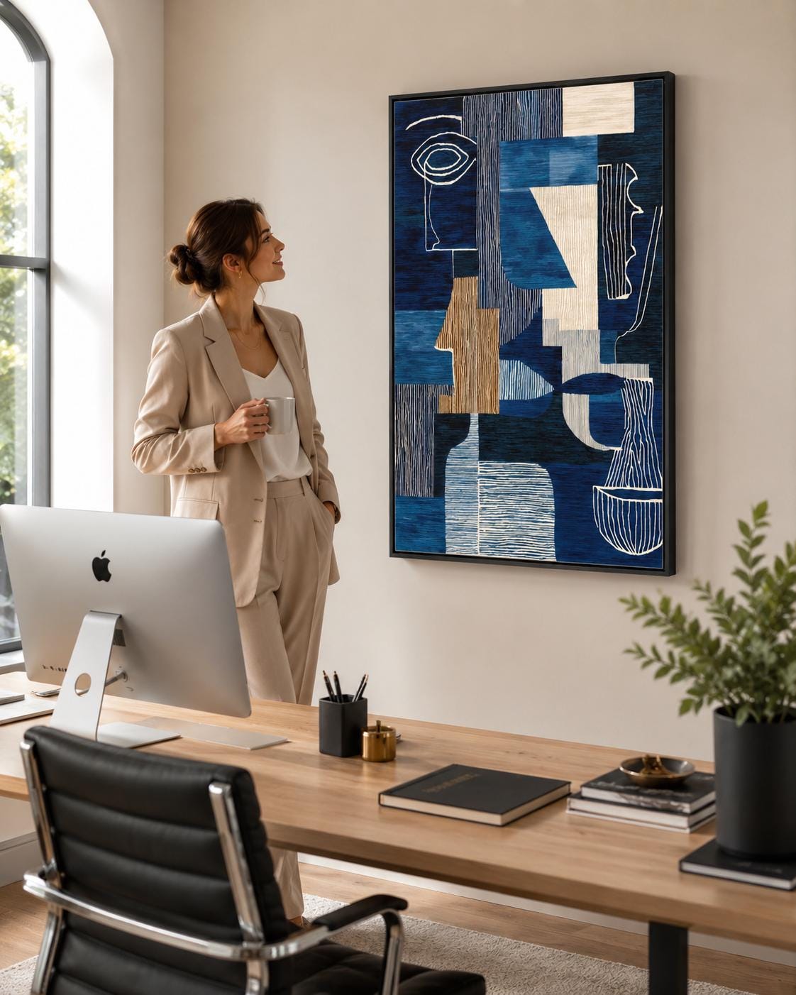 Woman holding a cup in a cafe-like space with a framed blue abstract face artwork on the wall