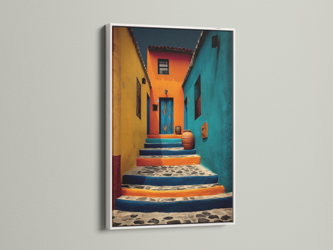 A colourful architectural courtyard scene shows sunlit steps, stucco walls and doorways in turquoise, orange and yellow tones detail view