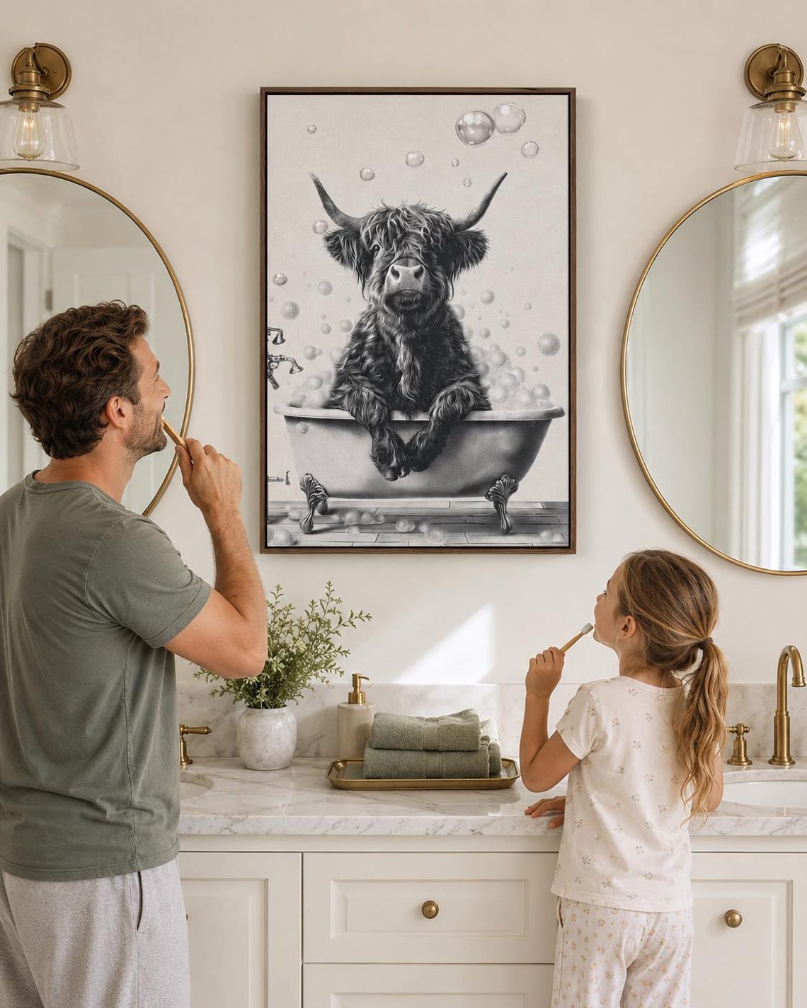 Woman holding a mug standing beside a framed monochrome highland cow bathtub artwork
