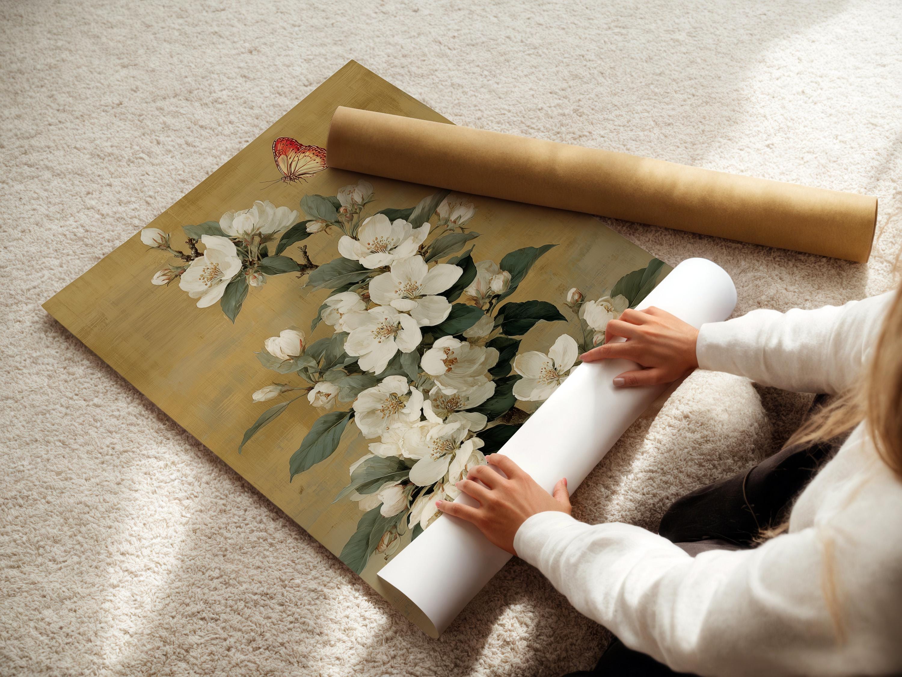 Vertical framed artwork mockup on a light wall with a bouquet of white blossoms and a butterfly