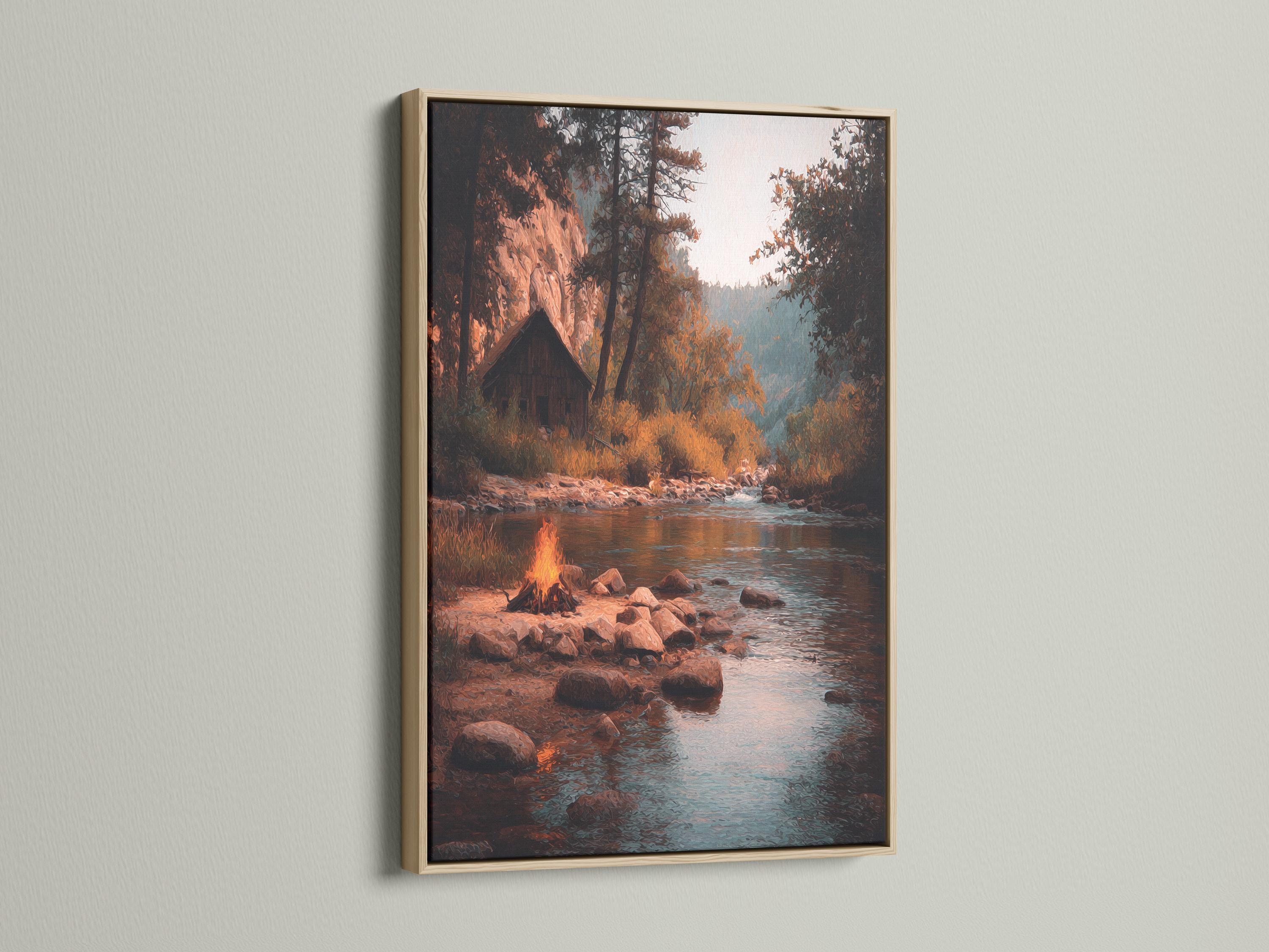 Moody river landscape with a warm campfire glow, rocks, trees and reflections on teal water detail view