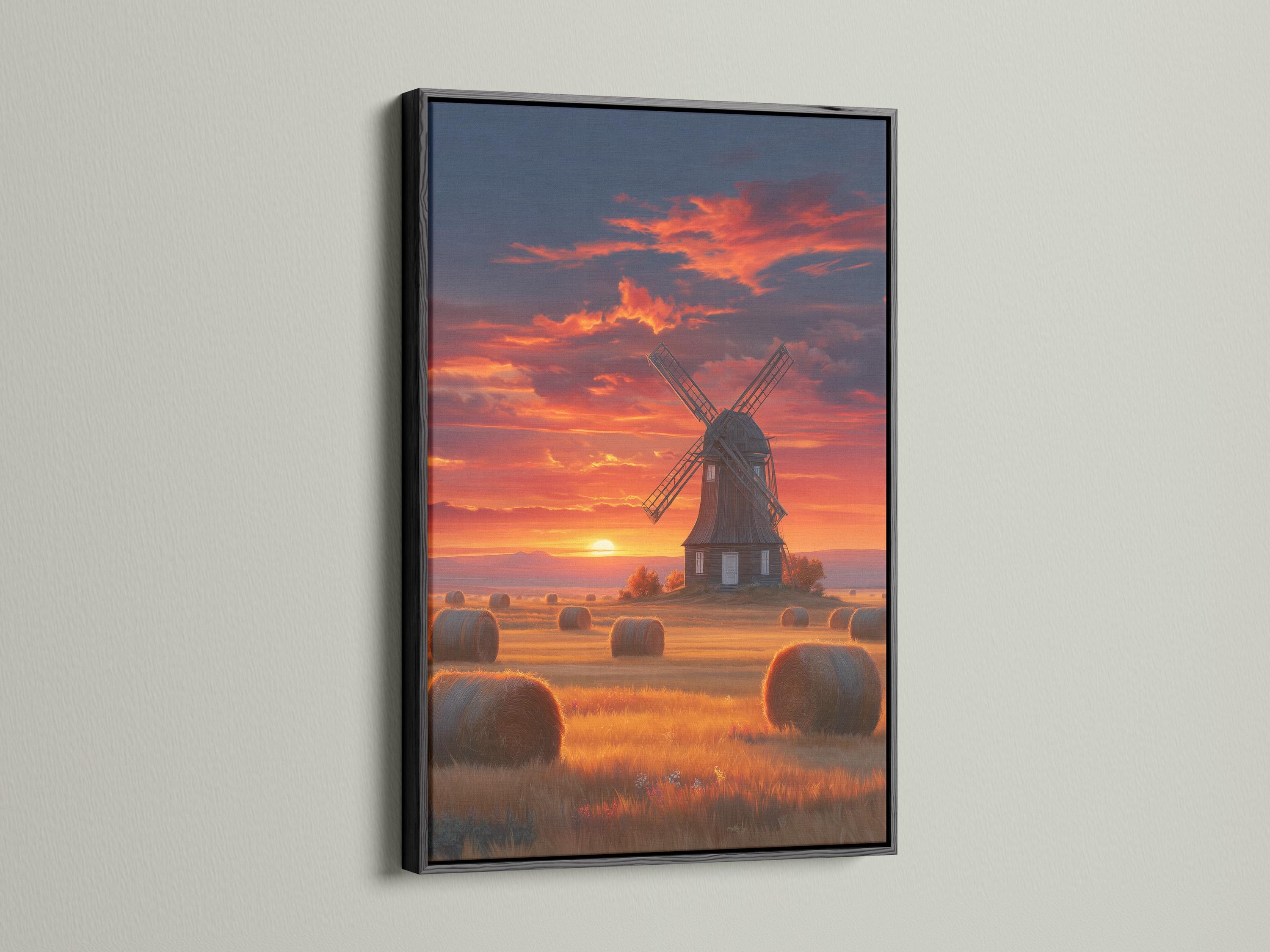 Windmill in a countryside landscape under a glowing sunset sky with hay bales detail view