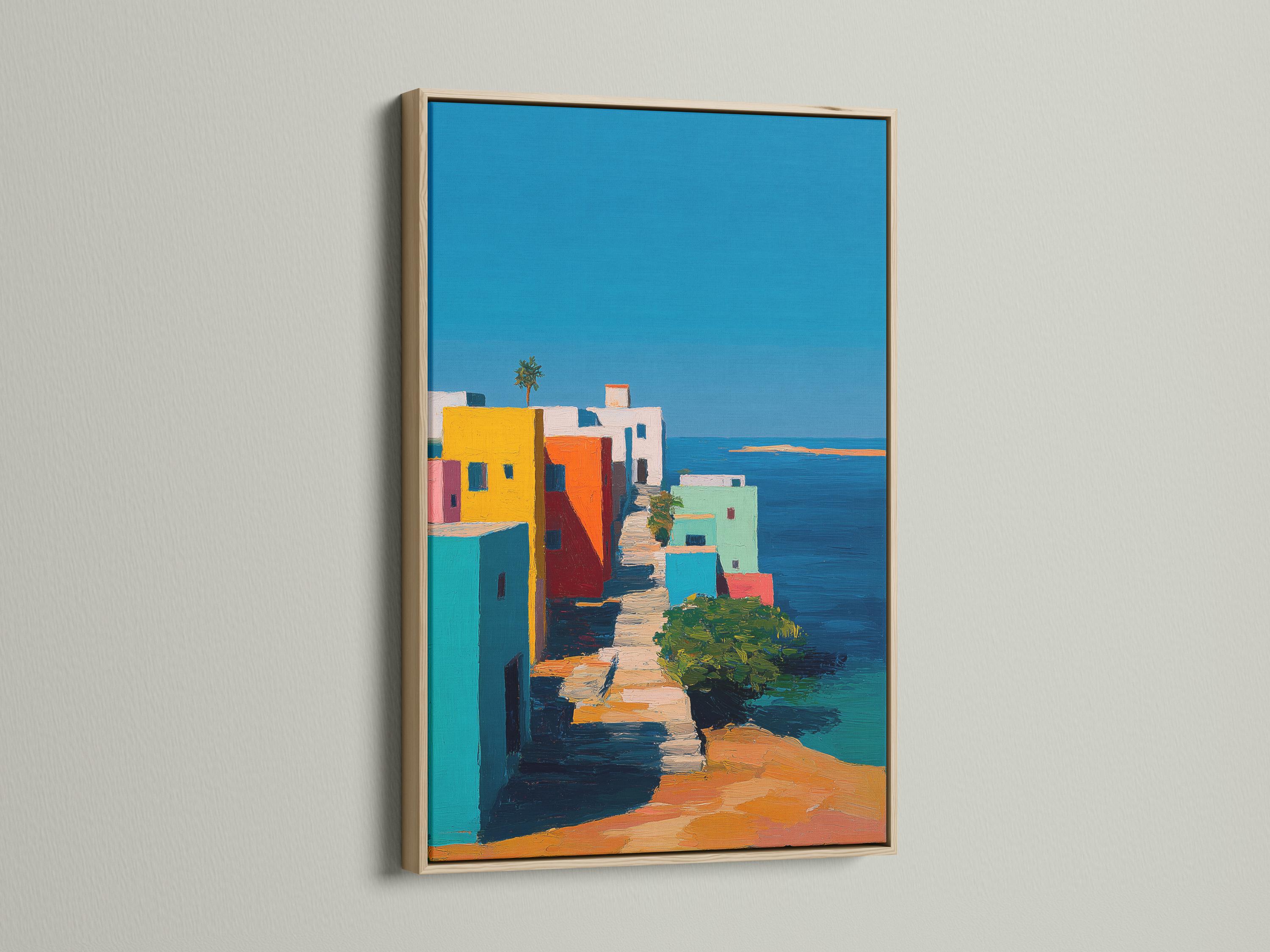 Wall mockup showing a framed coastal village artwork with colourful buildings and blue sky