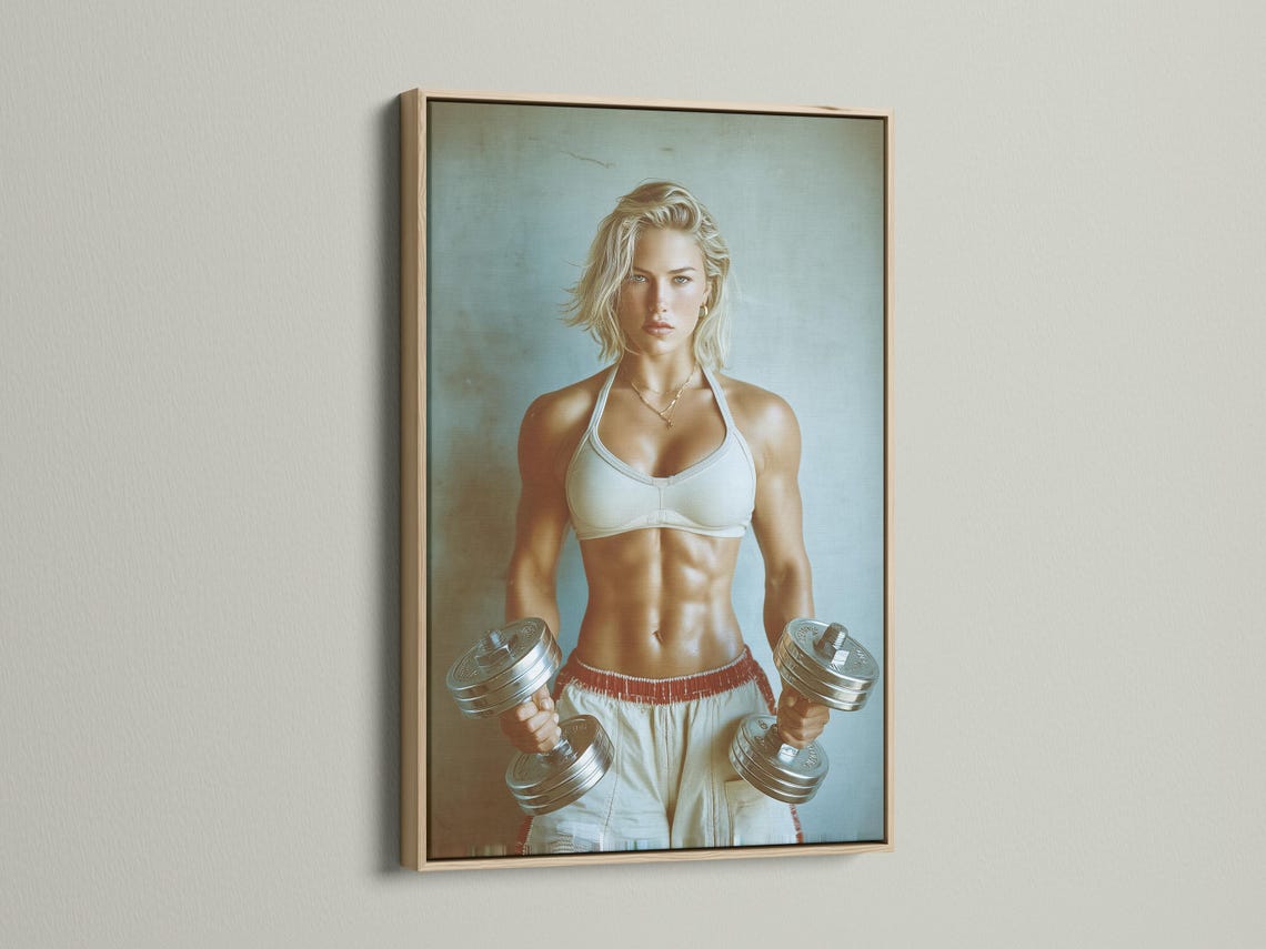 Room mockup showing a framed fitness portrait of a woman holding dumbbells on a teal background