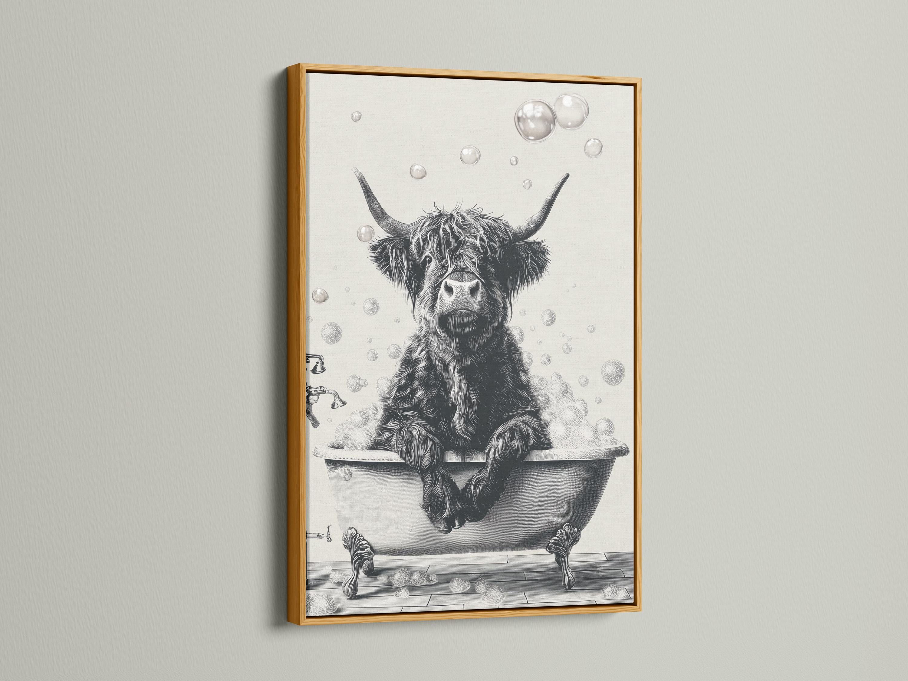 Woman holding a mug standing beside a framed monochrome highland cow bathtub artwork