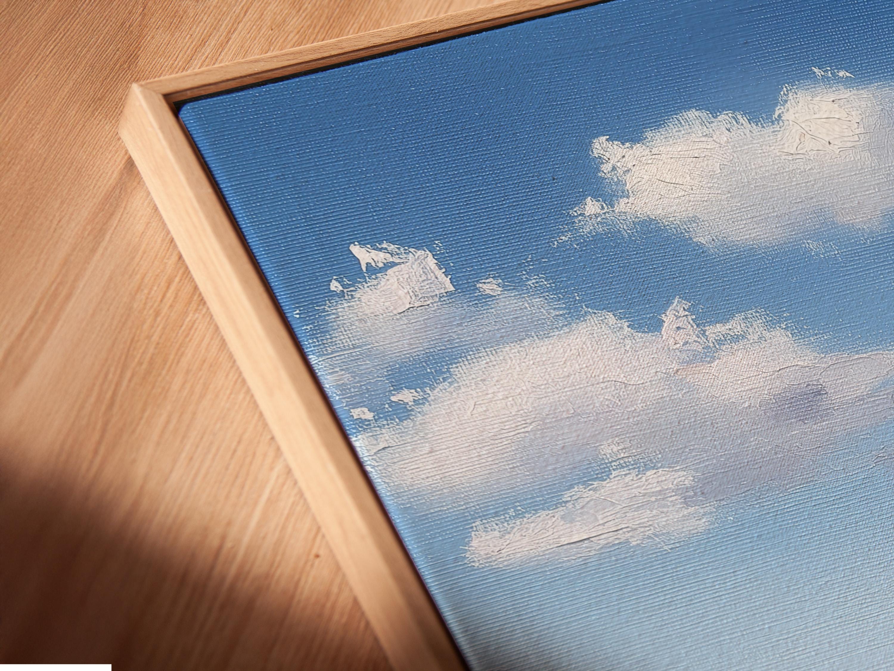 Blue ocean seascape with fluffy white clouds and foamy waves over sandy shore detail view