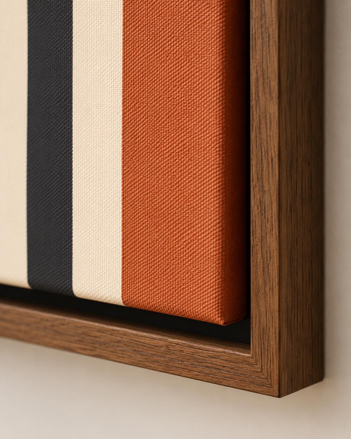 Living room scene featuring three framed geometric stripe artworks