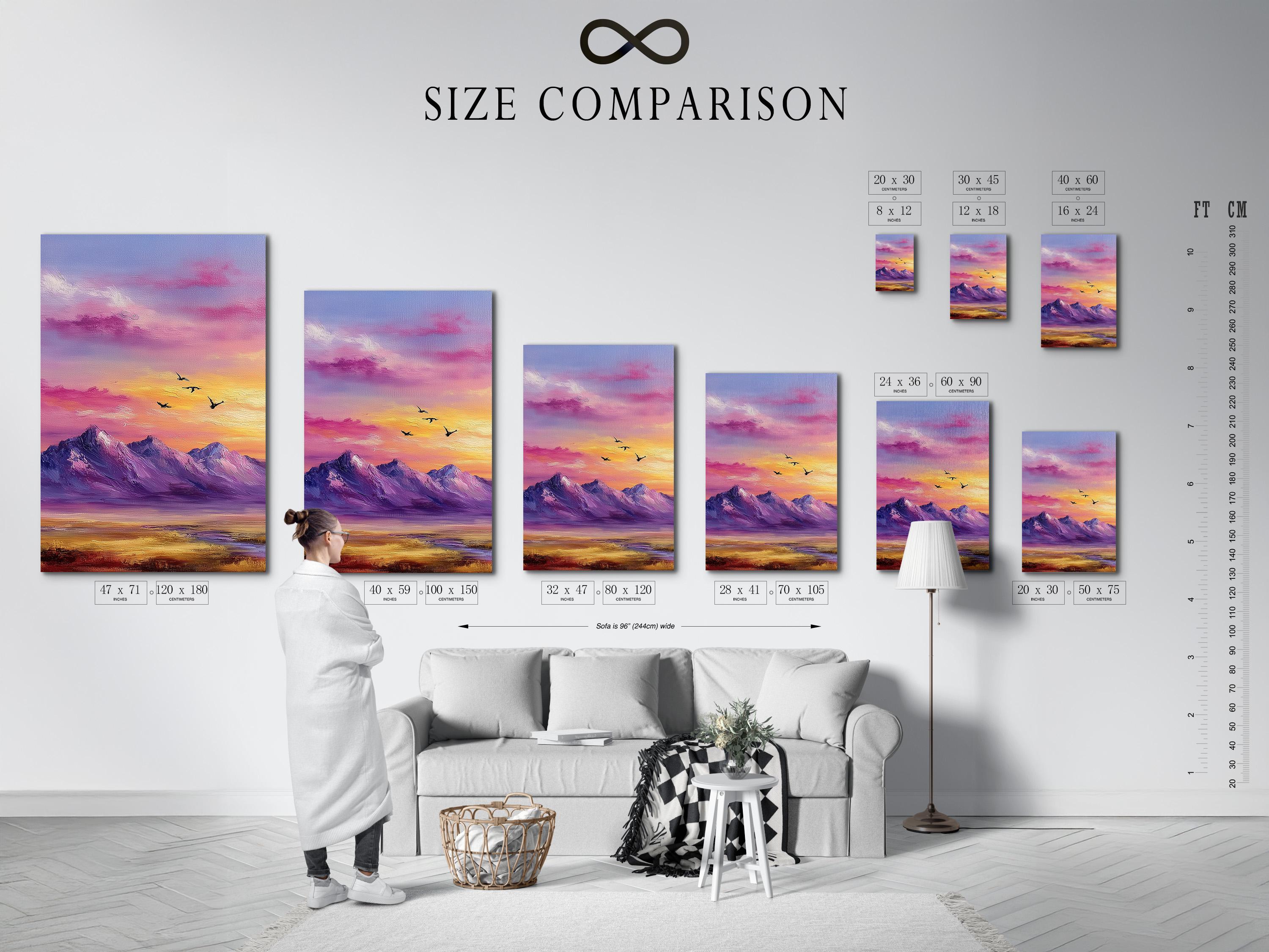 A framed mountain sunset illustration with purple, pink and gold skies and small black birds detail view