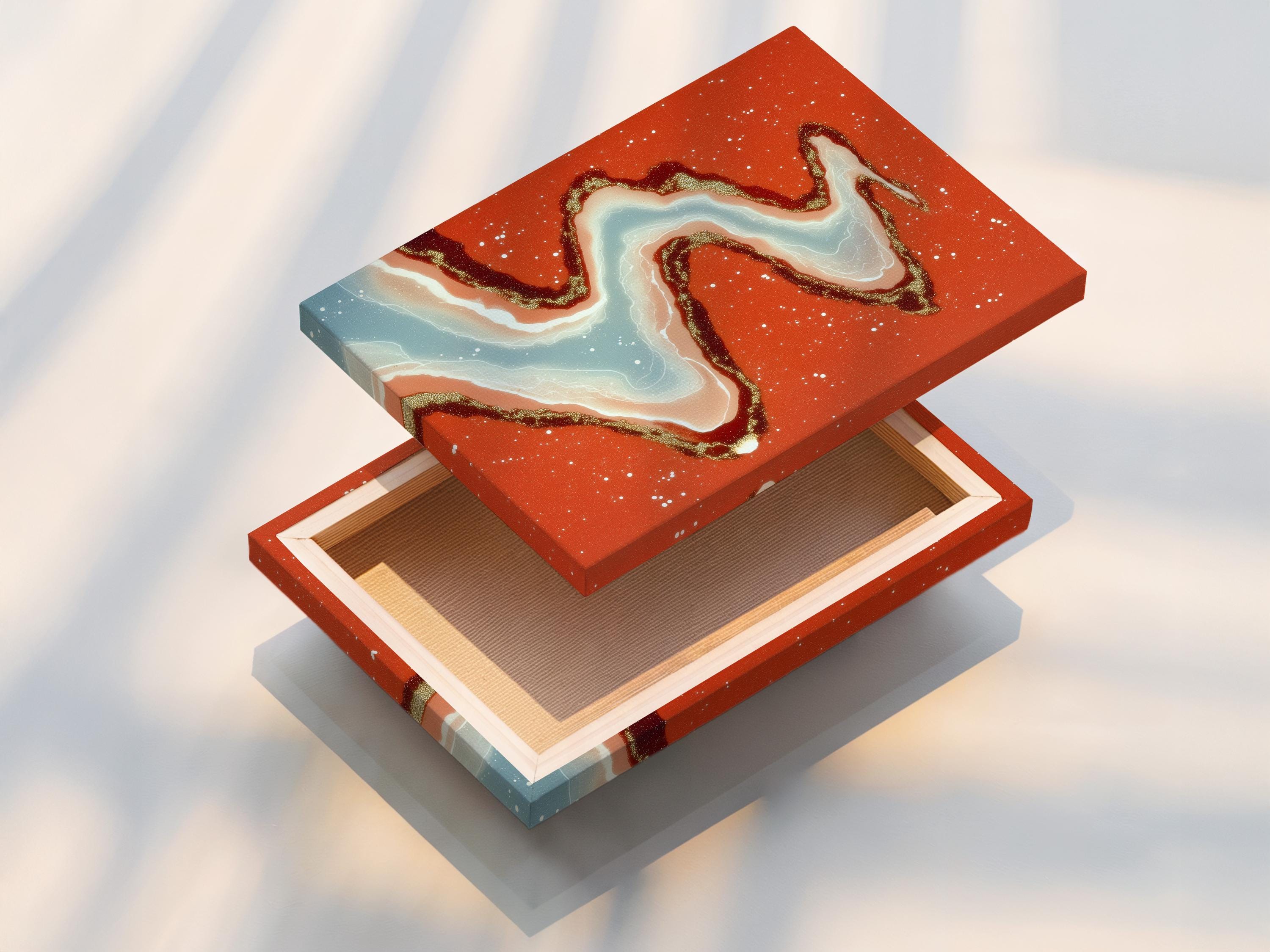 Abstract river ribbon in pale blue and cream with gold speckles over a terracotta background detail view