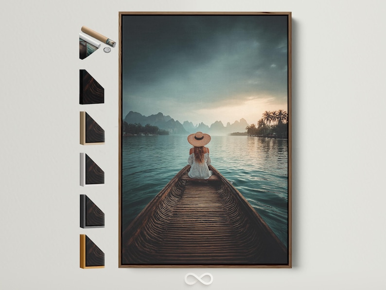 Woman in straw hat sits on a boat facing calm teal water, mountains and a warm sunrise sky